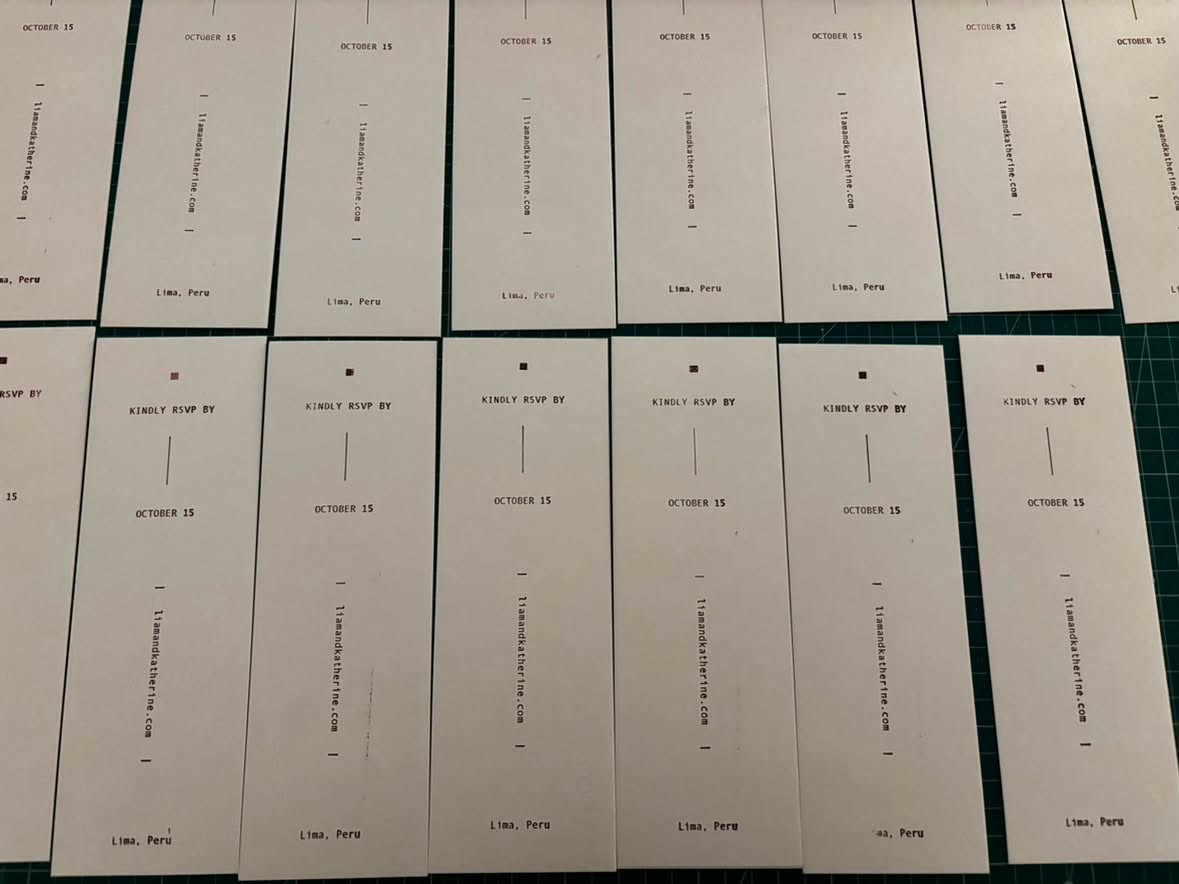 Printed RSVP cards laid out on a cutting mat
